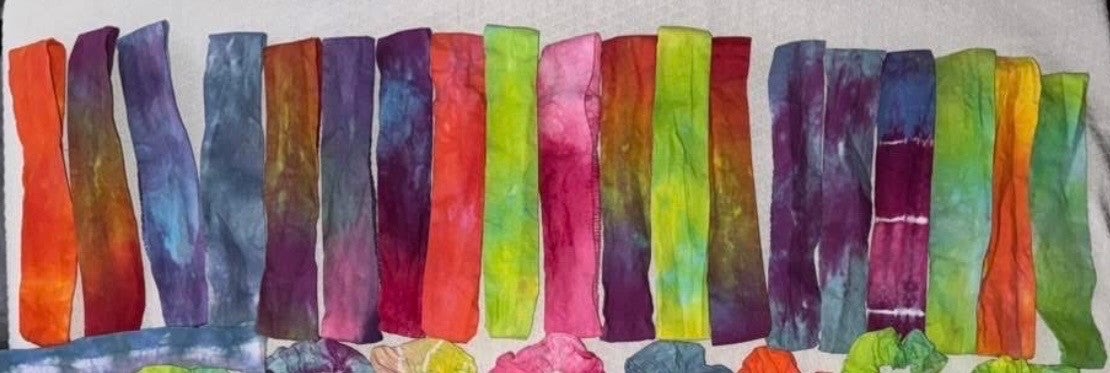 A row of colorful tie-dye headbands