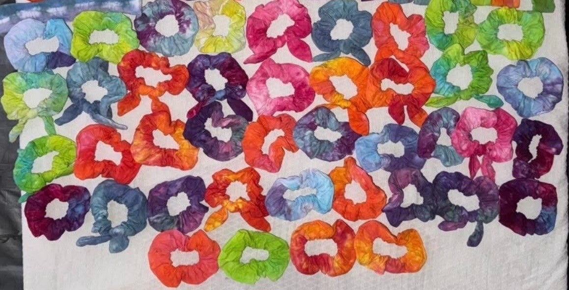 A pile of rainbow tie-dye scrunchies